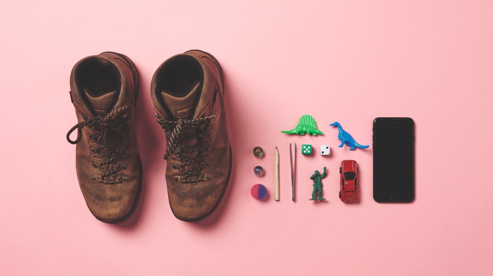 walking boots, toys and phone for geocaching